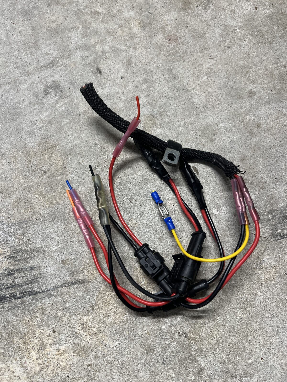 A spidery mess of separate crimps hanging off the original wiring harness